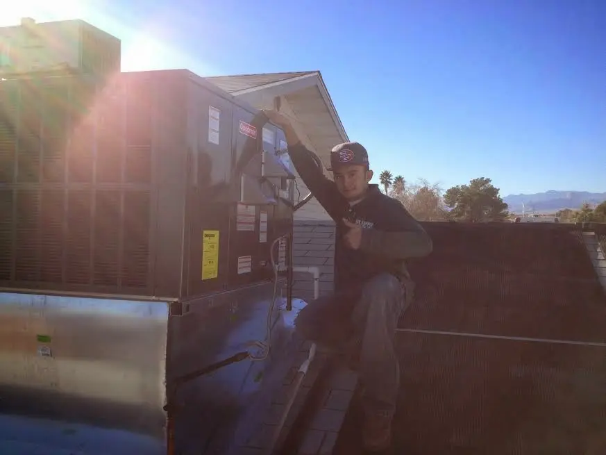 HVAC technician performing Boiler Repair on a rooftop unit in Upper Saucon